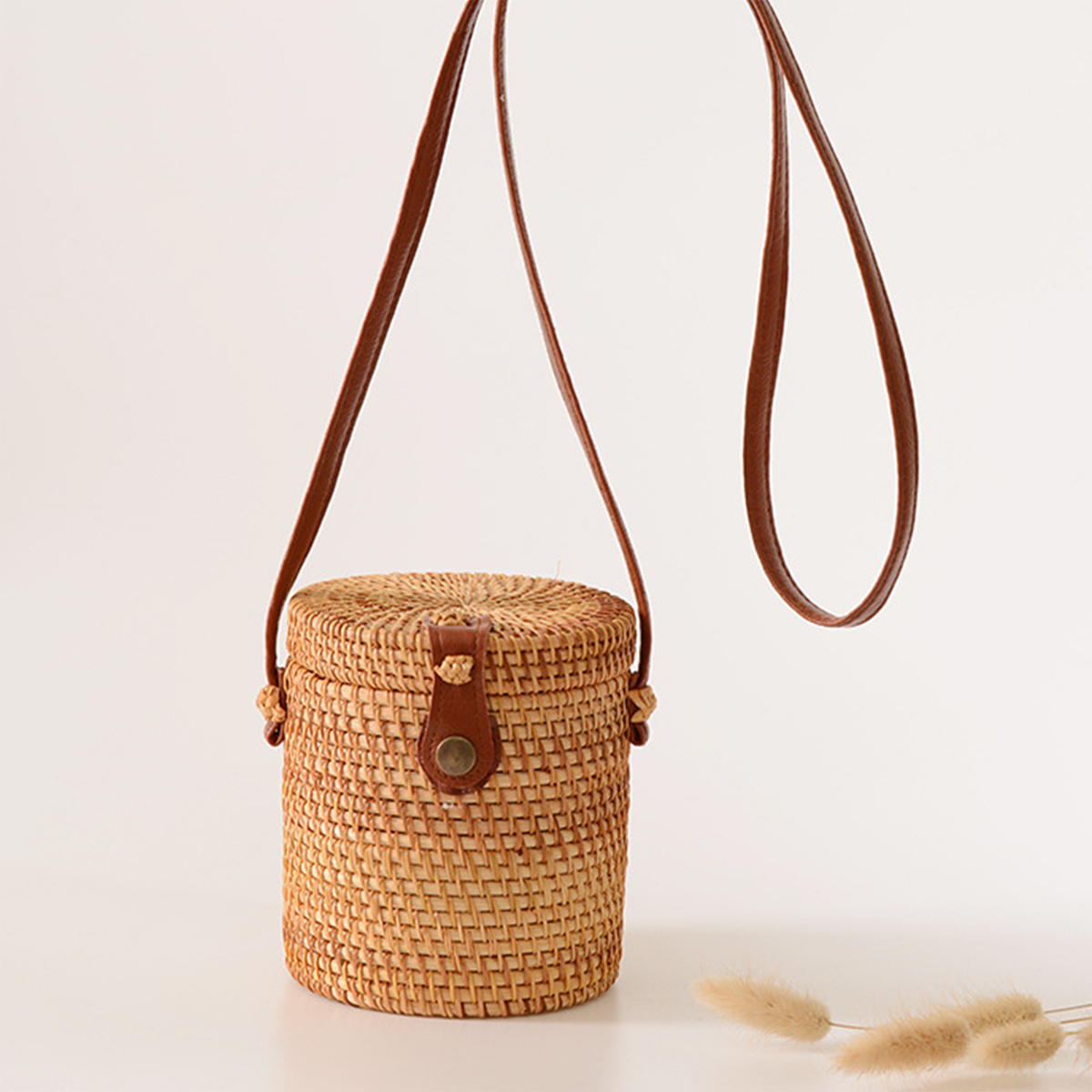 Light brown natural rattan cylindrical crossbody bag