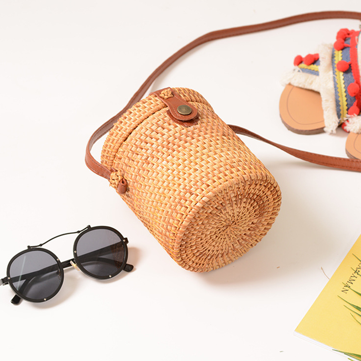 Light brown natural rattan cylindrical crossbody bag