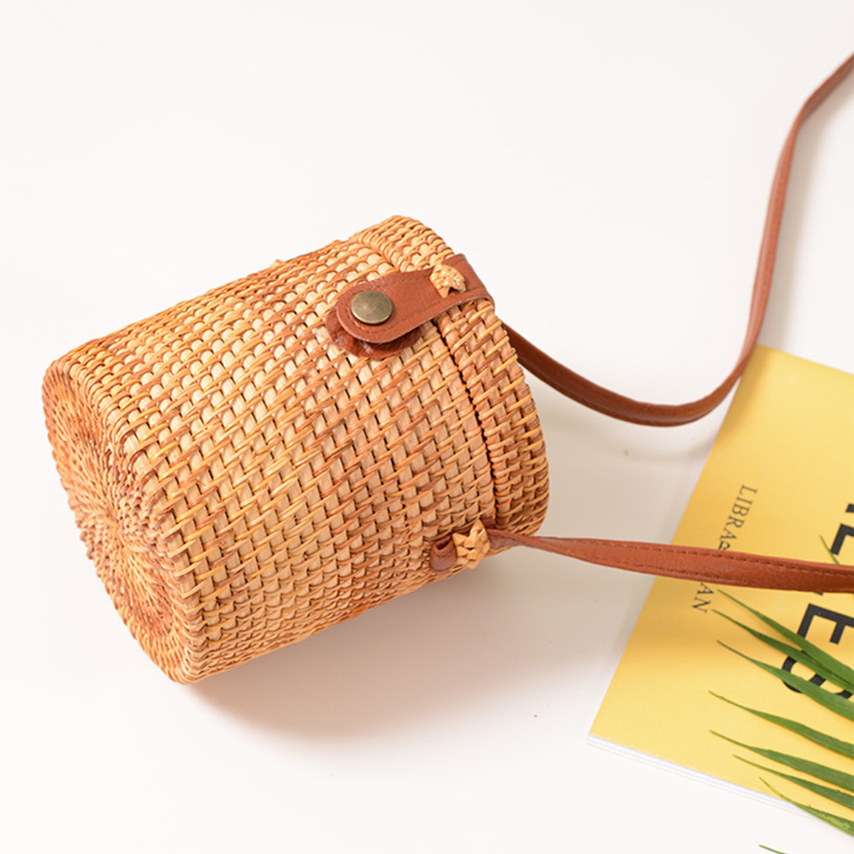Light brown natural rattan cylindrical crossbody bag
