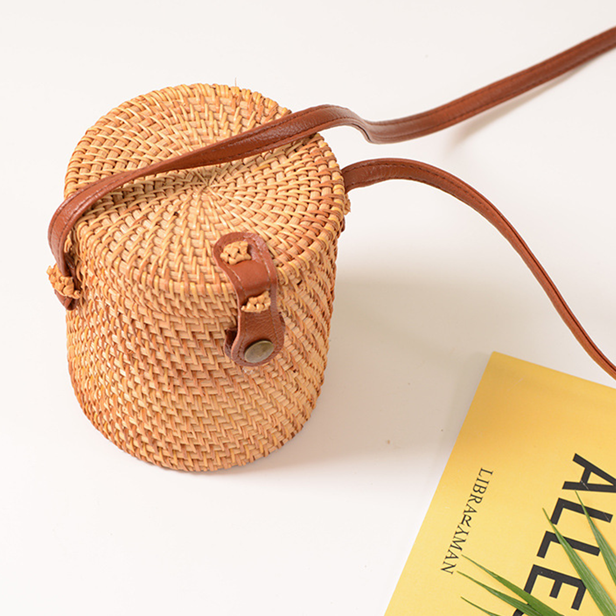 Light brown natural rattan cylindrical crossbody bag